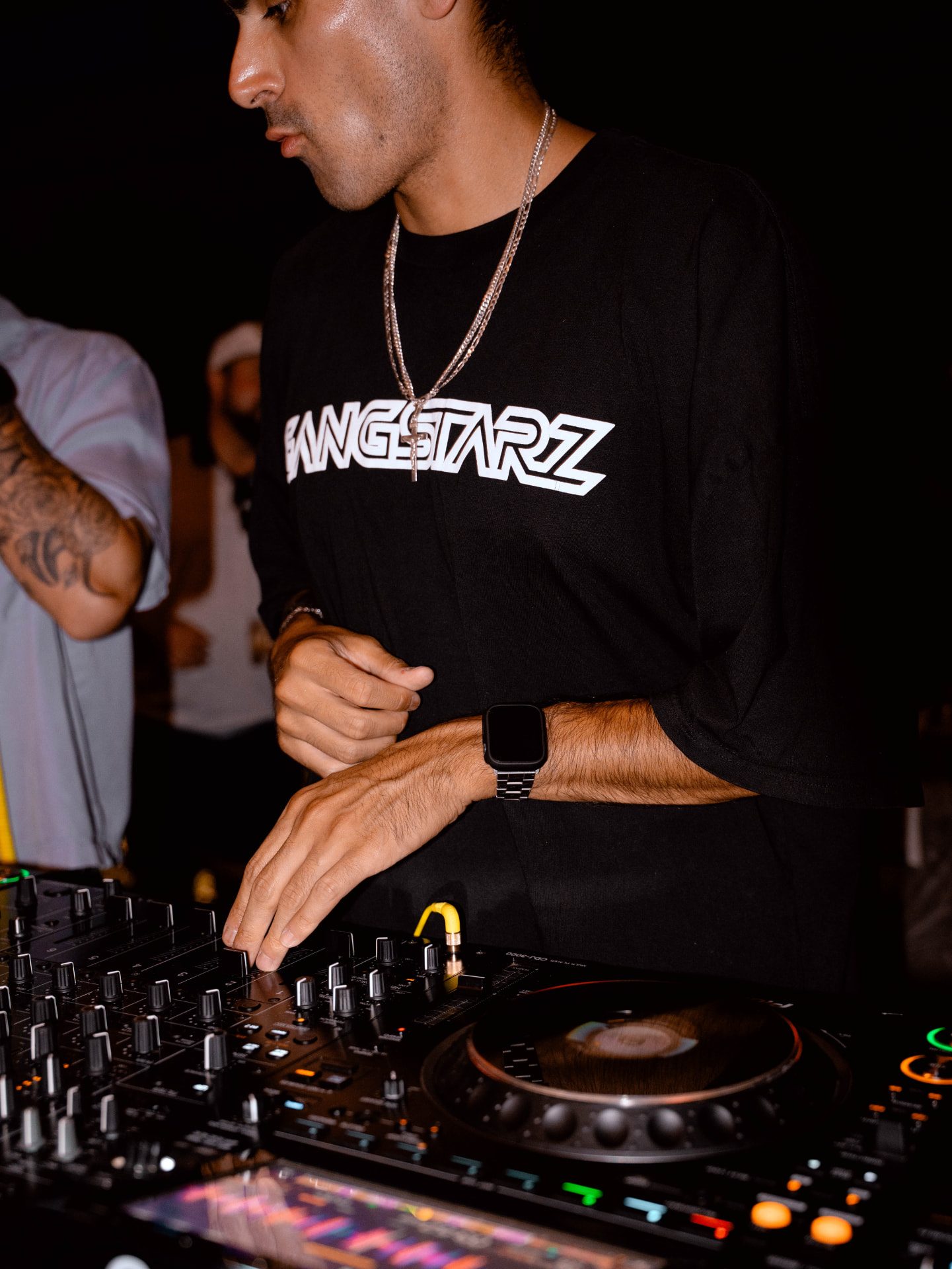 BINO mixing on a Pioneer DJ mixer at a live show